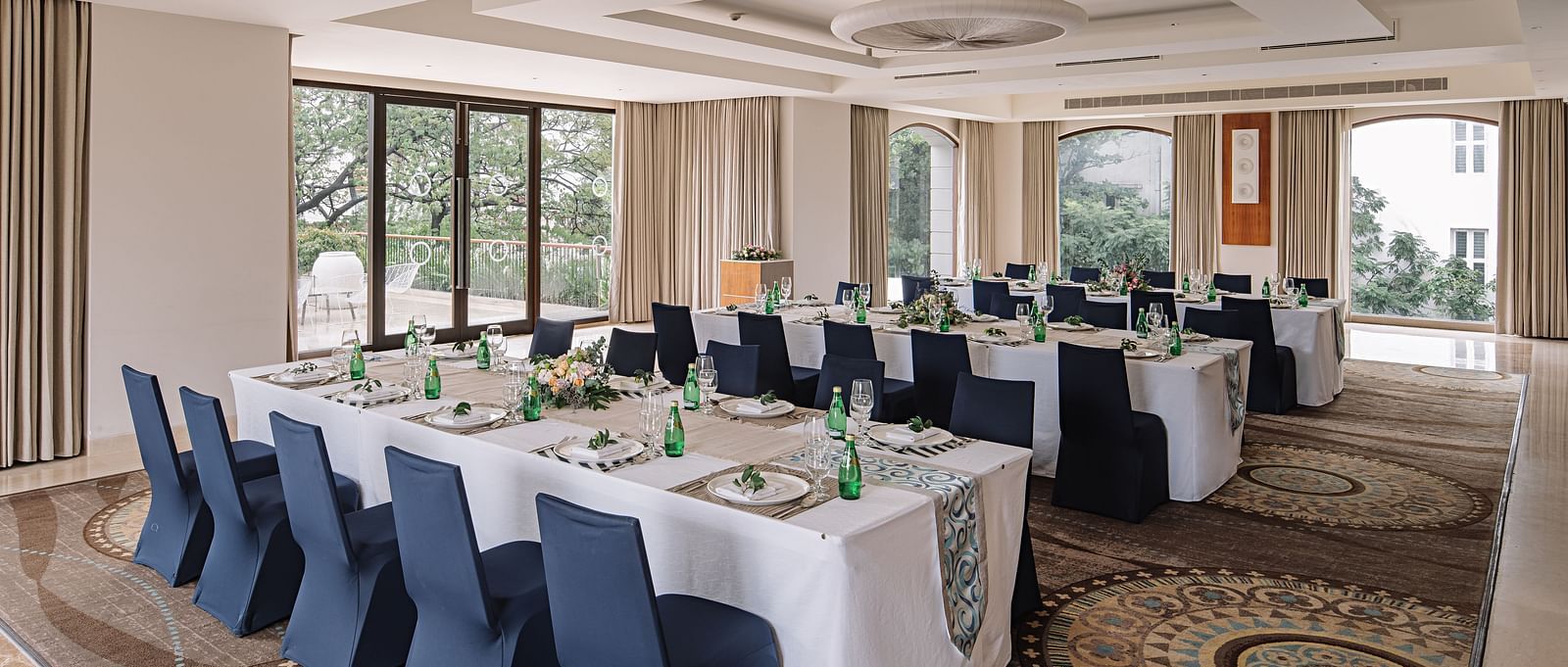 A hall with a rectangle table with chairs arranged beside it at The Raintree Hotel, St. Mary's Road.