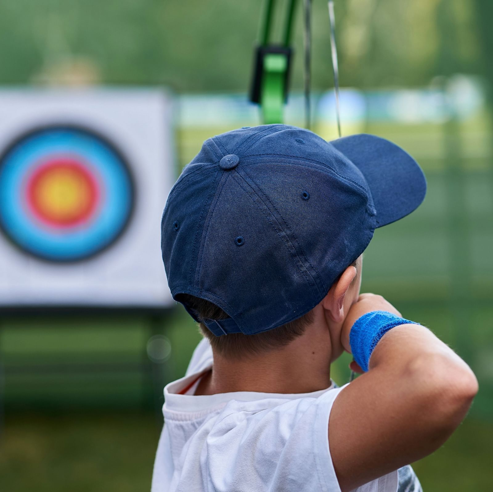 Image of a boy hitting the target with a bow and an arrow