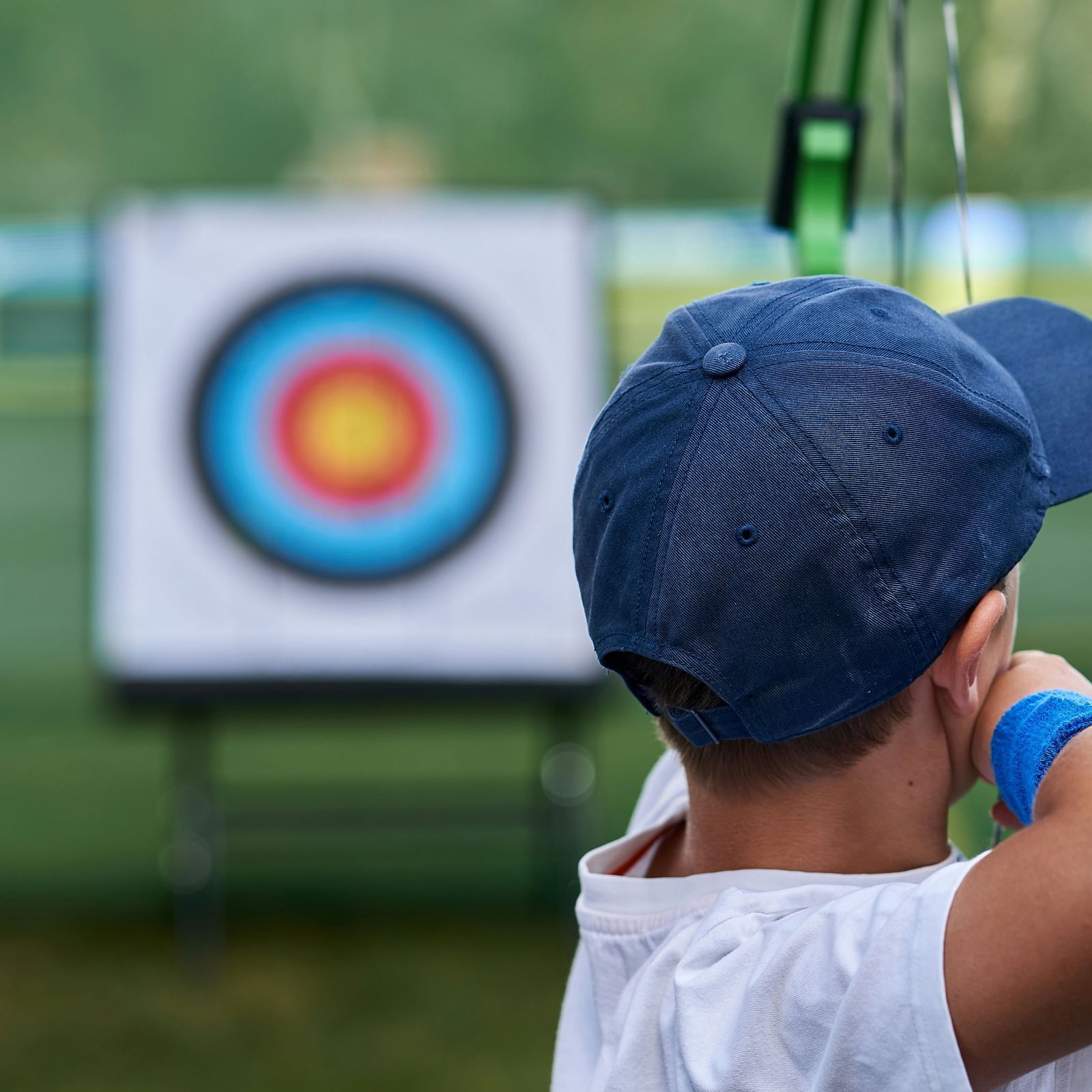 Image of a boy hitting the target with a bow and an arrow