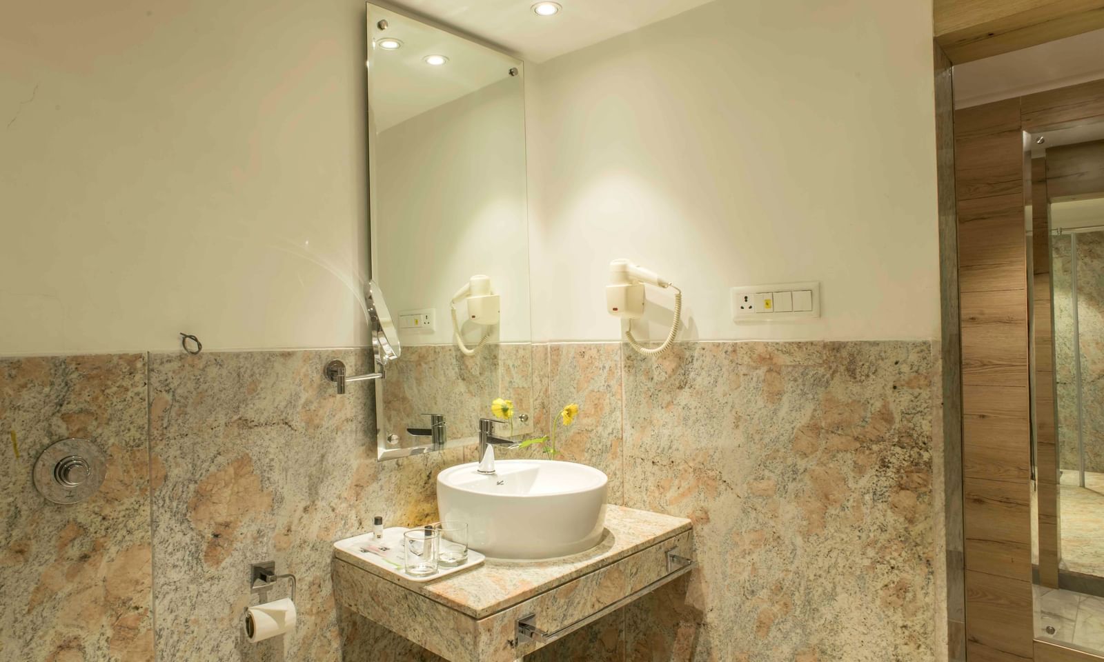 Modern bathroom with a stylish sink and a large mirror at The Citi Residenci Hotel Durgapur