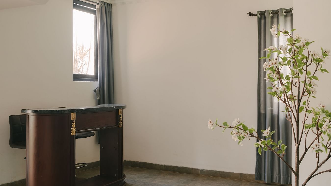 Spacious and minimalistic corner with a wooden console in the Three BHK Deluxe Villa at Richmonde Ananta Elite, Goa.