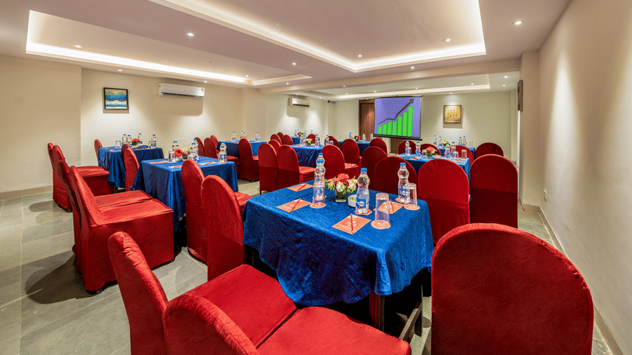  Lords Eco Inn conference area with tables covered in cloths and chairs.