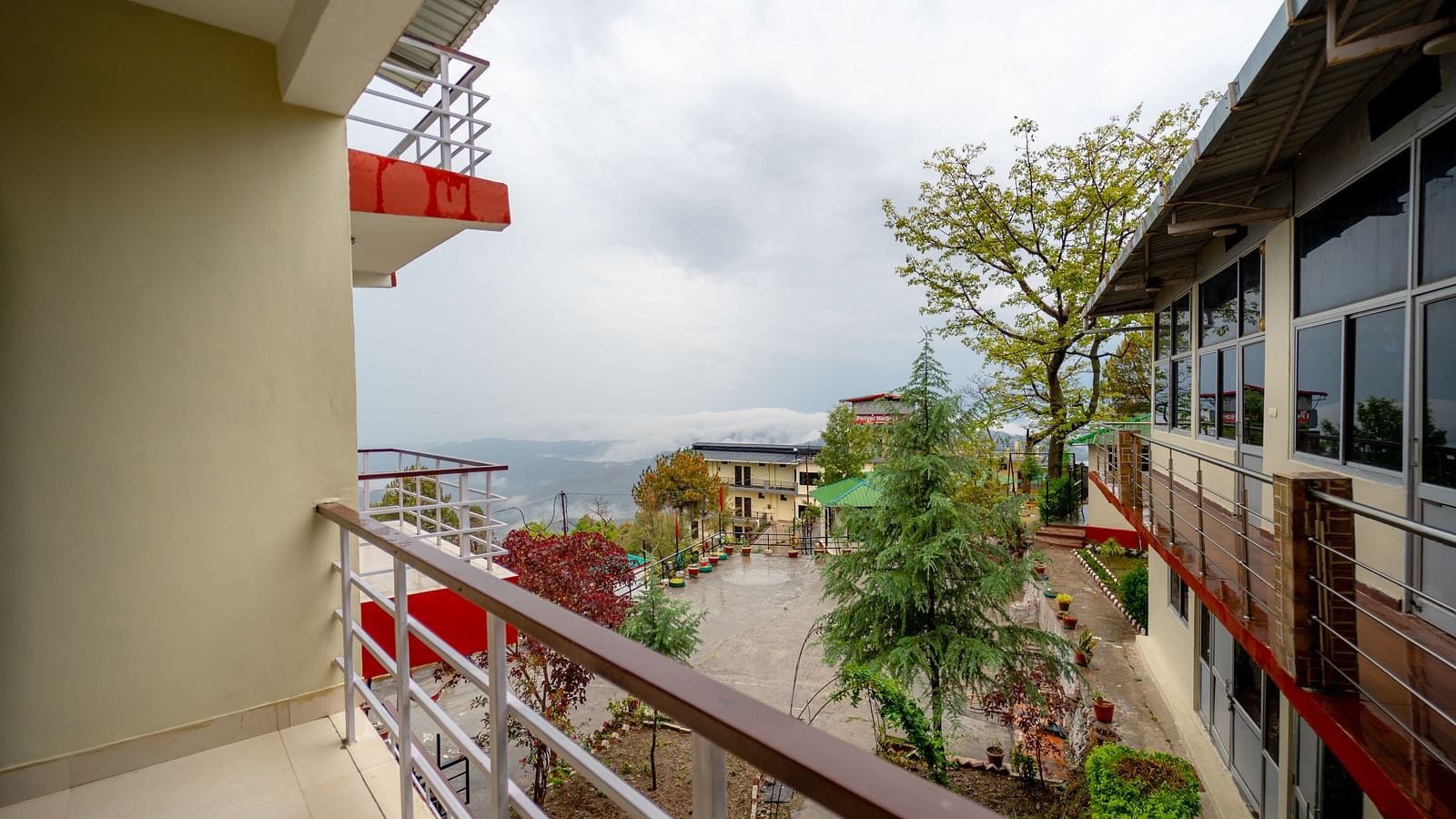 a balcony offering a view of the garden at Flutter Hotels & Resorts