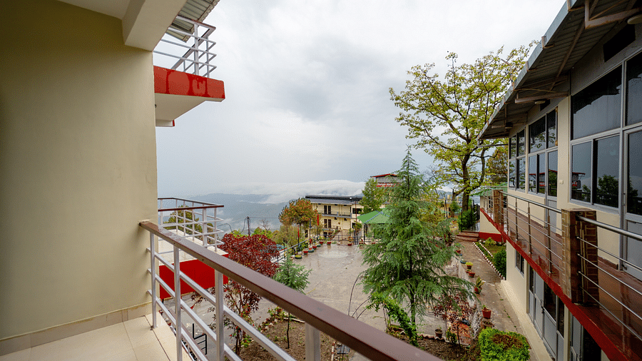 a balcony offering a view of the garden at Flutter Hotels & Resorts