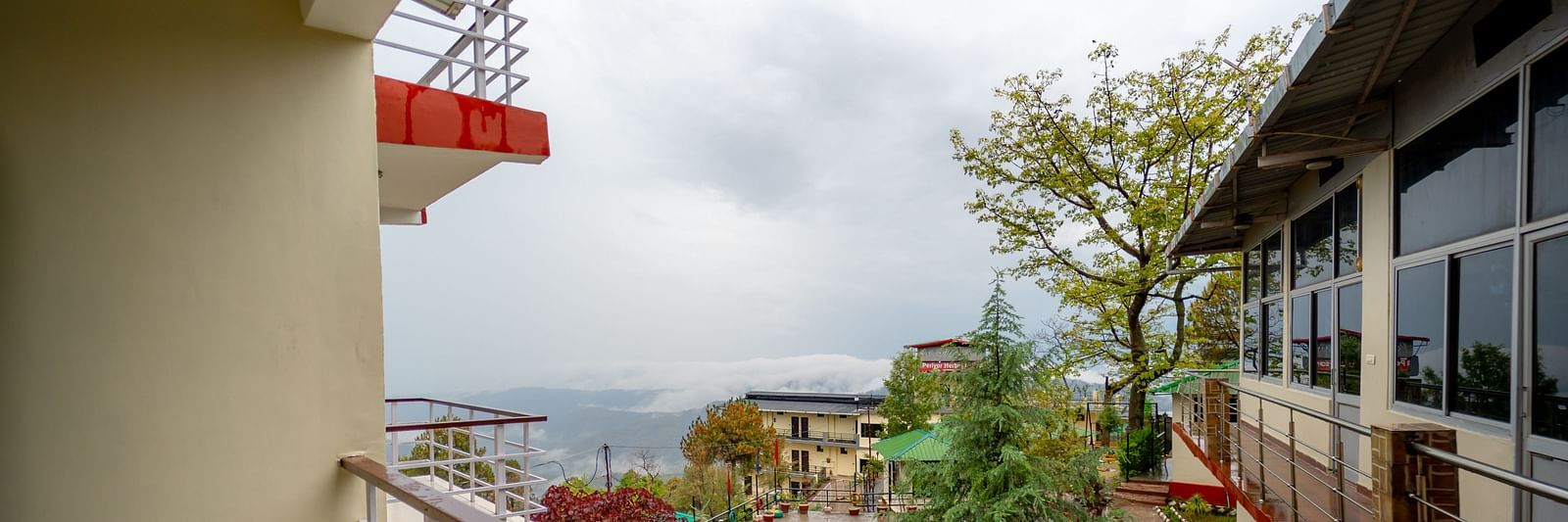 a balcony offering a view of the garden at Flutter Hotels & Resorts