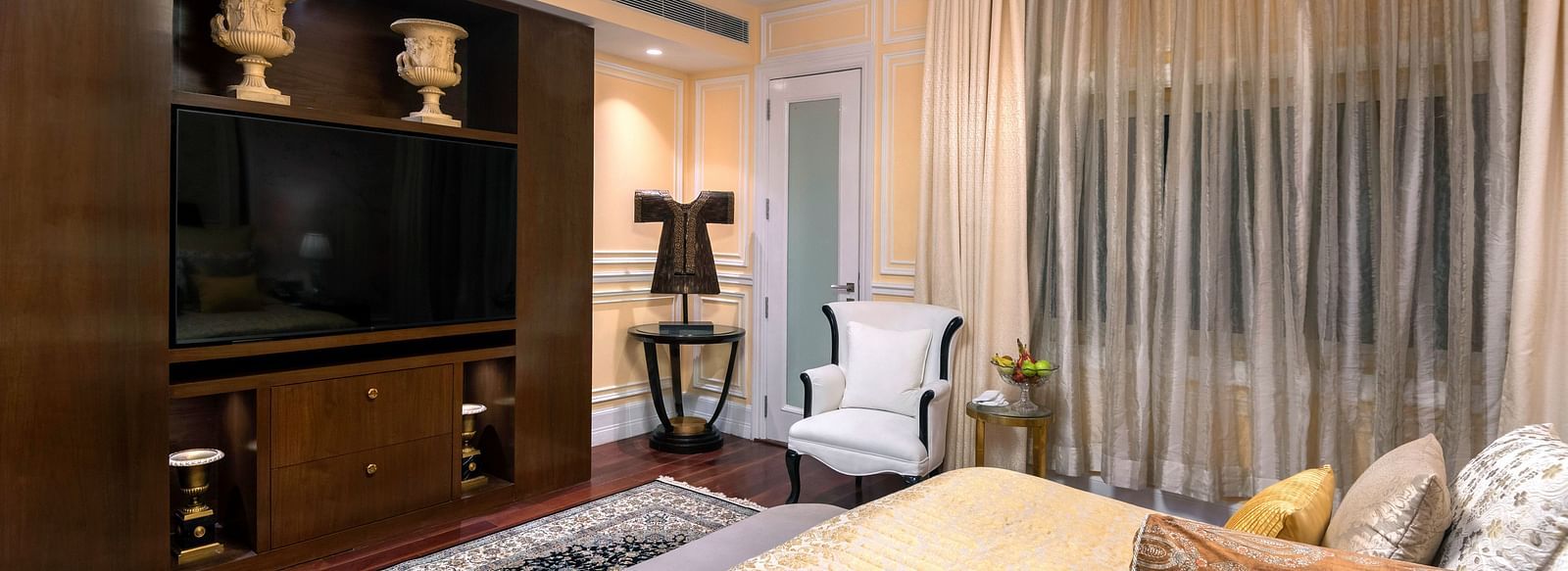 Prestige room with bed and a television in front of the bed at The Claridges, New Delhi