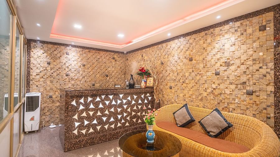 Image of a reception area with a sofa and a table in front at Parampara Residency, Kushalnagar.