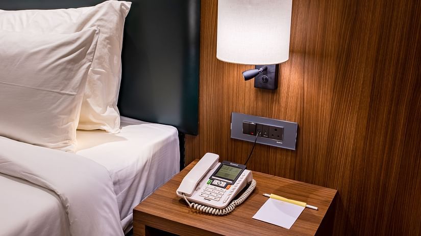 a telephone kept on the side table in one of the rooms - The Wedlock Greens Hotel & Resort, Dhanbad
