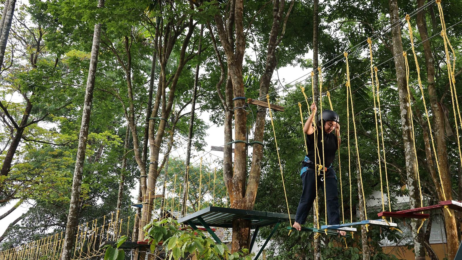 Image of a person experience the adventurous activities at the play area | Great Trails Wayanad by  GRT hotels. 