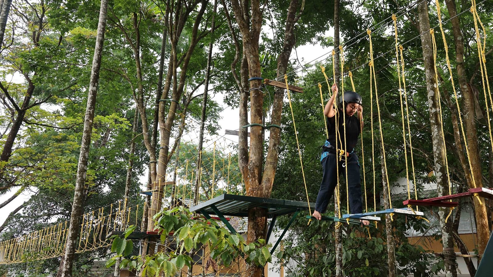 Image of a person experience the adventurous activities at the play area | Great Trails Wayanad by  GRT hotels. 