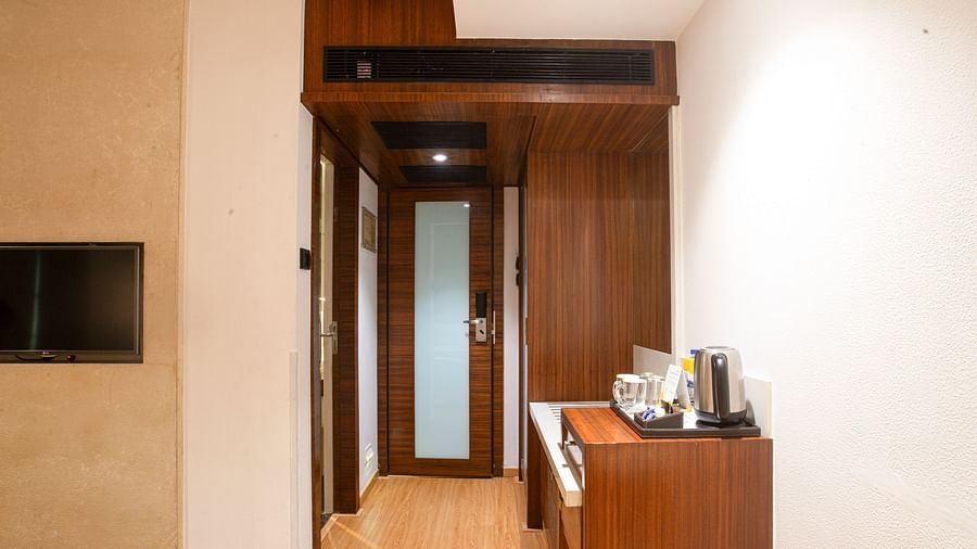 A lobby area of the executive room featuring a table with basic items such as a kettle, sugar, and other essentials, creating a welcoming space.