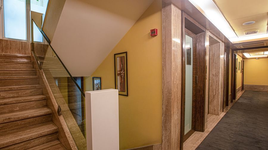 A view of the corridor highlighting the staircase and lift, showcasing the layout and design of the space.