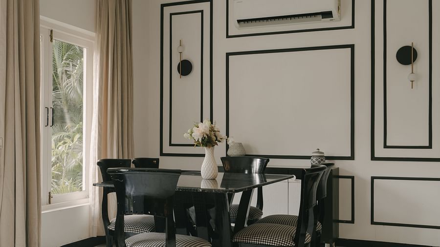 Elegant dining area with black-and-white panelled walls in Three BHK Premium Villa, Richmonde Ananta Elite, Goa.
