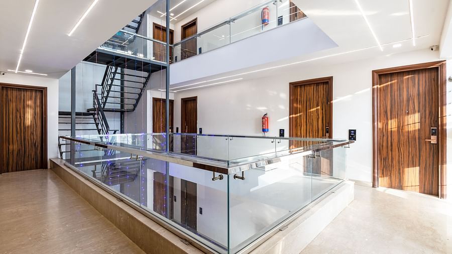 Modern hotel lobby with glass railings at Hotel Bawa, Gurgaon.