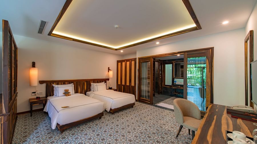 An image of a large bedroom with two beds placed  - Alibu Resort Nha Thrang