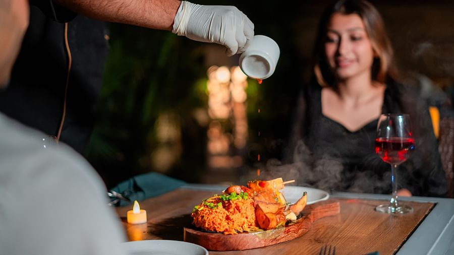 A chef attending to a couple by the poolside, creating a memorable dining experience at Crescent Spa & Resort, Indore
