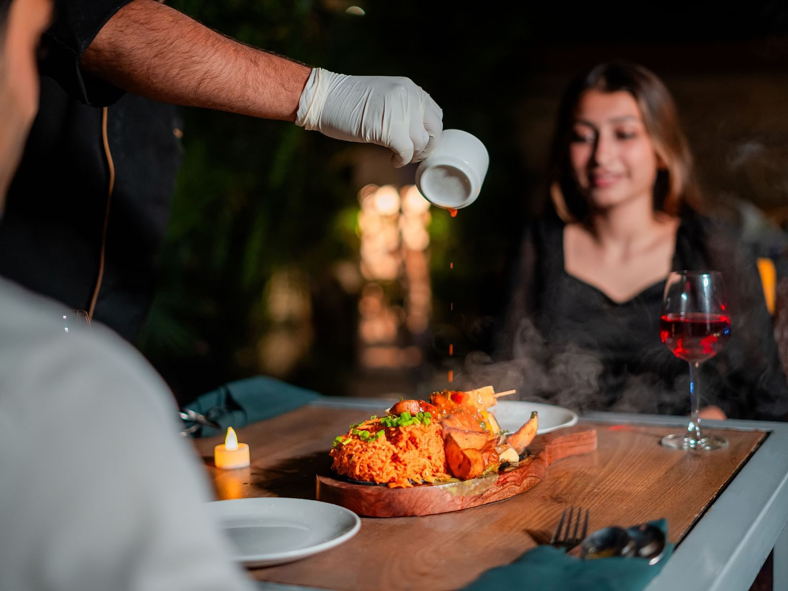 A chef attending to a couple by the poolside, creating a memorable dining experience at Crescent Spa & Resort, Indore