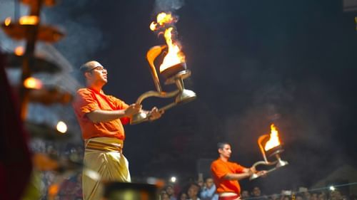 Priest performing aarti with diyas