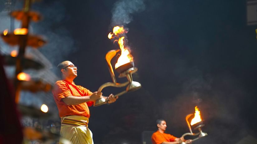 Priest performing aarti with diyas