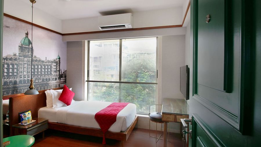 modern rooms with single bed and windows offering the panoramic views of mumbai