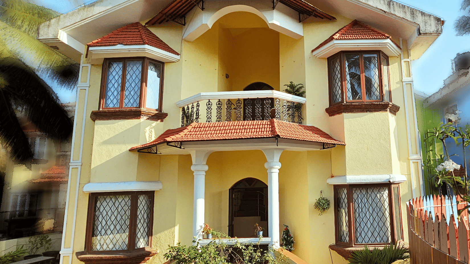 A bright exterior shot of the Amara Villa, Nagoa, featuring a beautiful entrance.