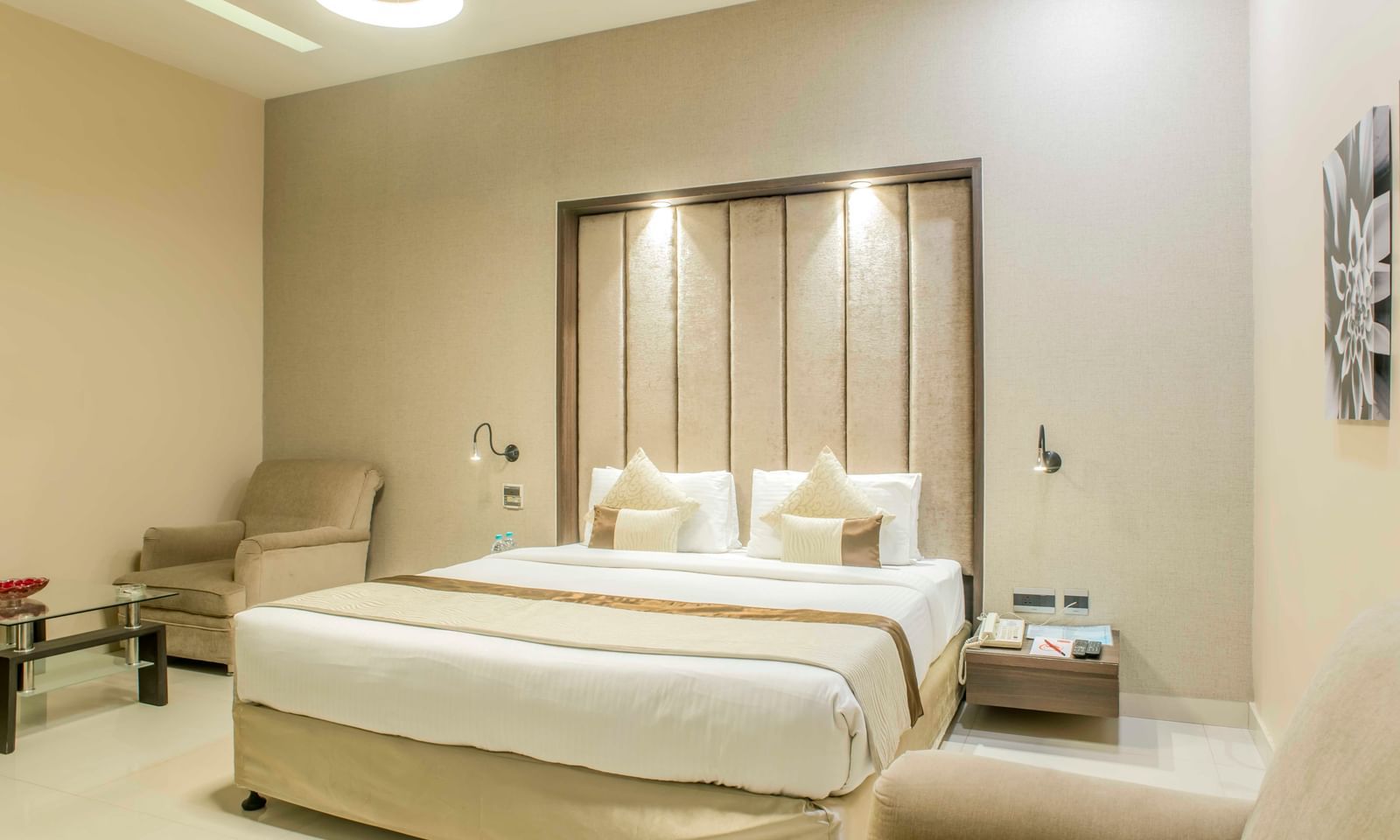 Tastefully decorated hotel room with a king size bed and a neutral colour scheme| The Citi Residenci Hotel Durgapur