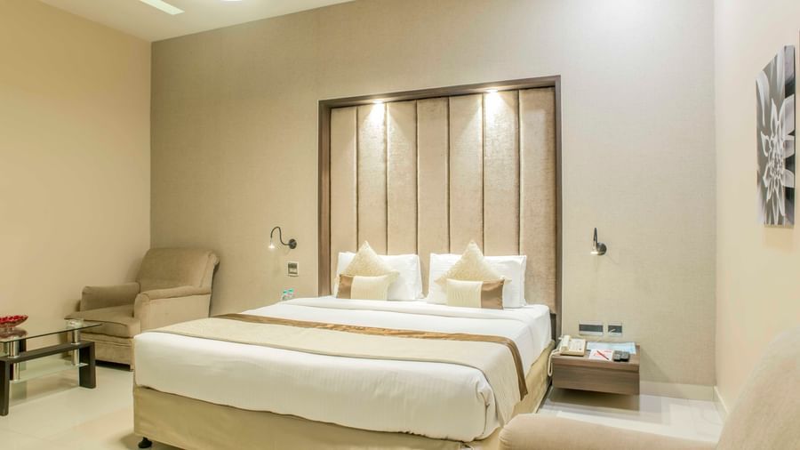 Tastefully decorated hotel room with a king size bed and a neutral colour scheme| The Citi Residenci Hotel Durgapur