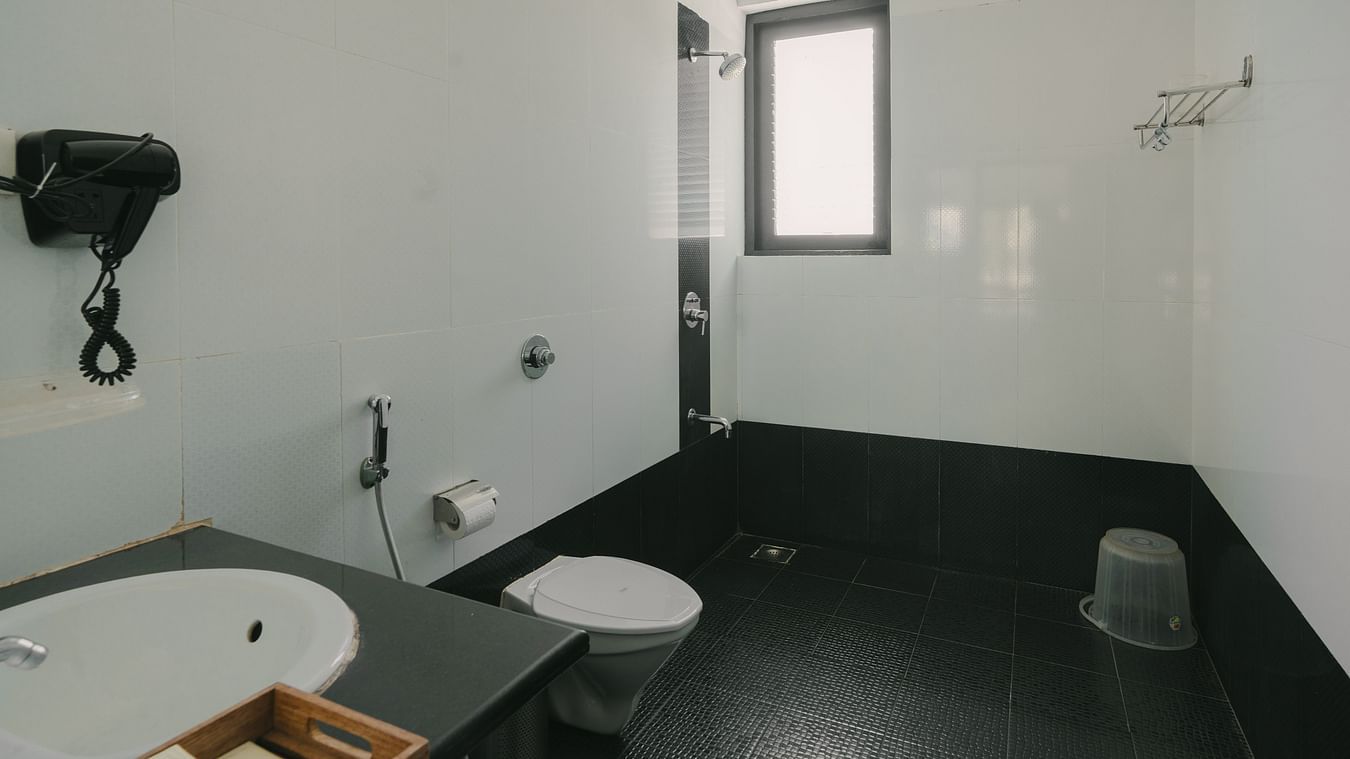 Modern bathroom with a spacious shower area in the Three BHK Deluxe Villa at Richmonde Ananta Elite, Goa.