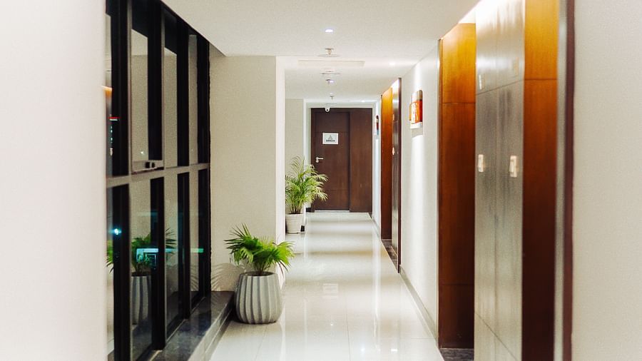 a passage with windows on one end and doors on the other - Jardin Hotels