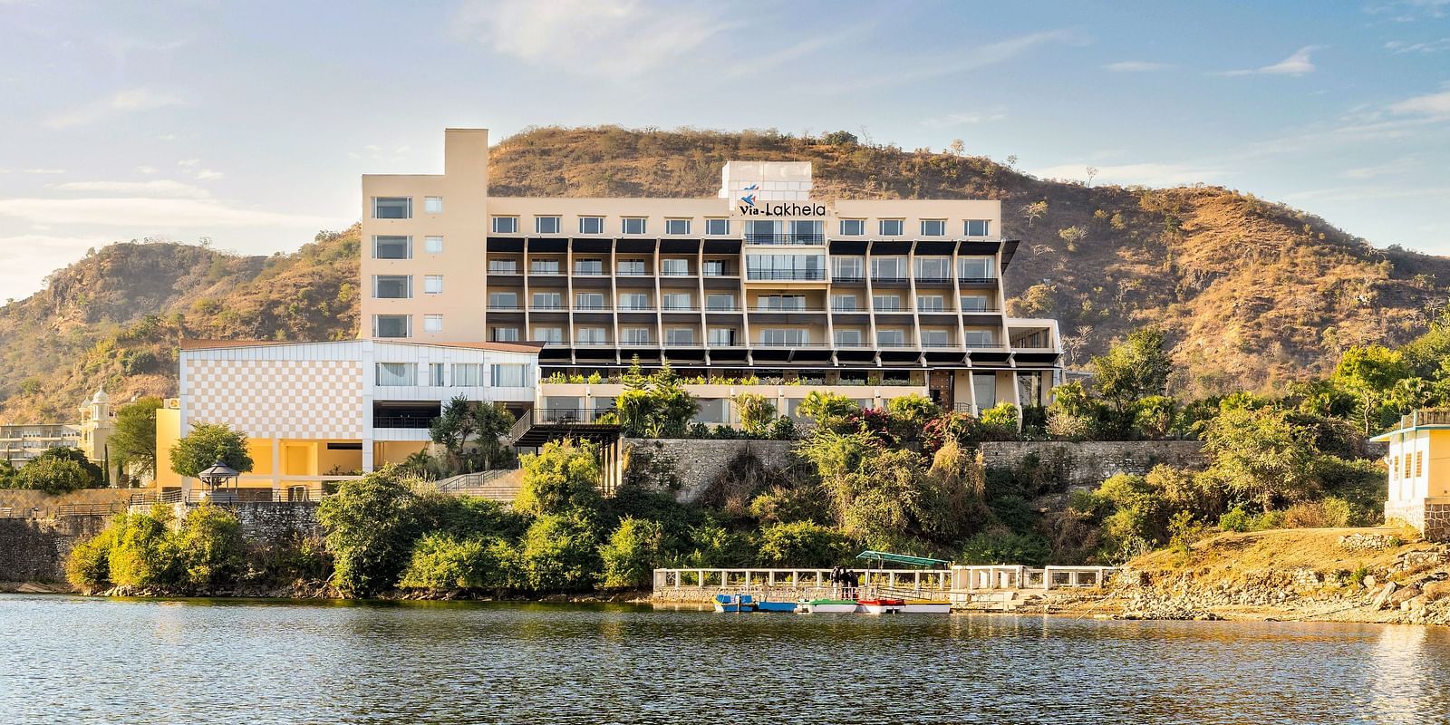 Resort exterior with the building on the hillside with a lake view - Via Lakhela Resort & Spa, Kumbhalgarh