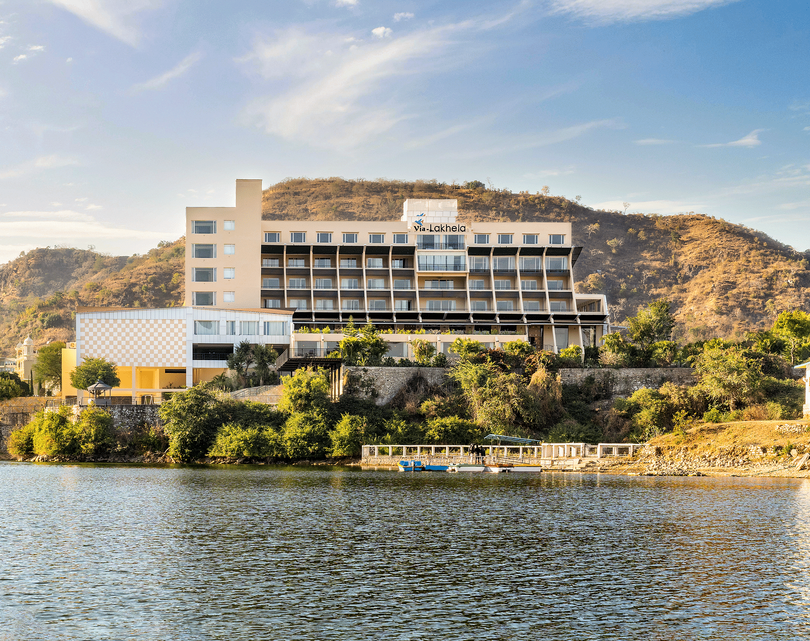 Resort exterior with the building on the hillside with a lake view - Via Lakhela Resort & Spa, Kumbhalgarh