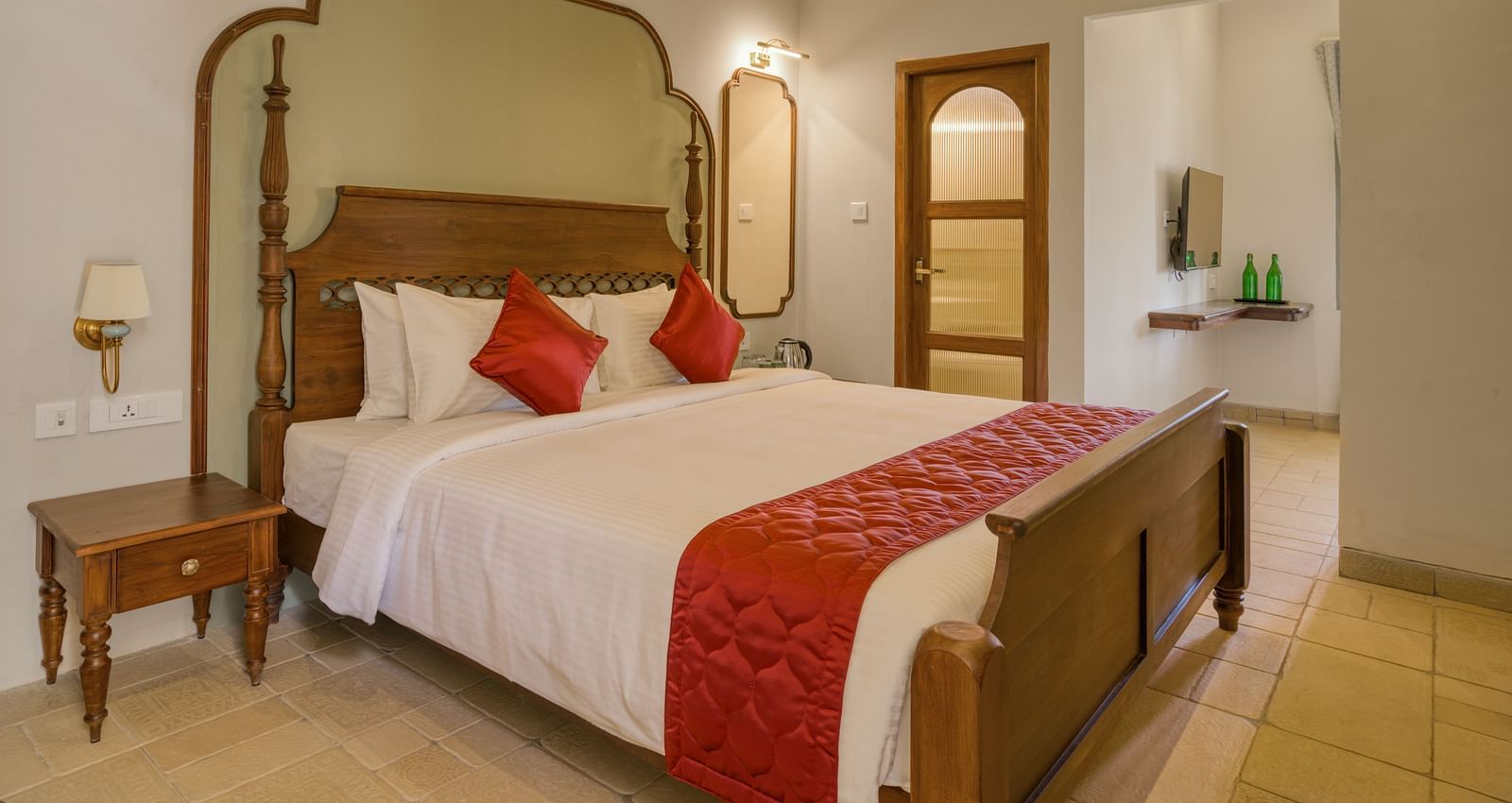 A double bed with side tables next to it inside the studio | Mango Hill Shola Ooty