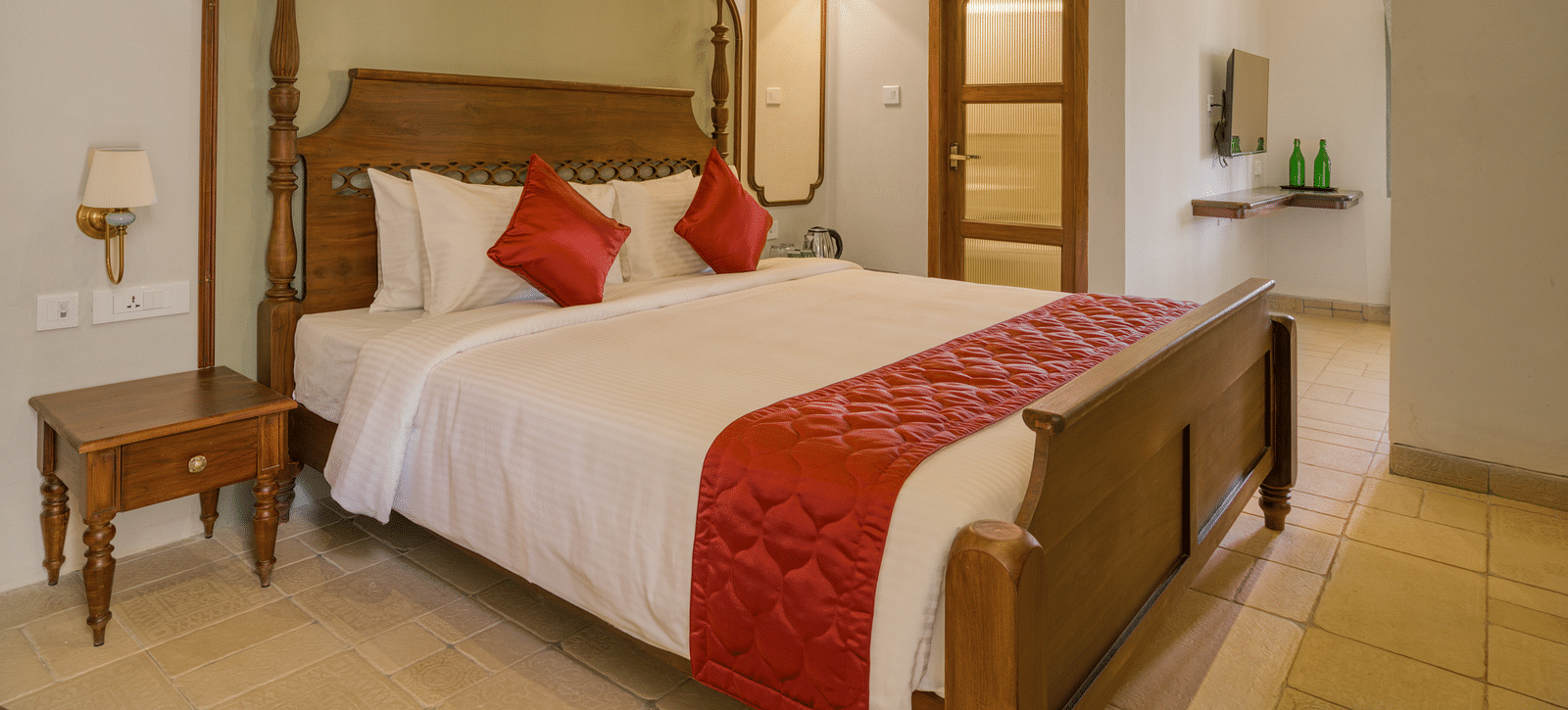 A double bed with side tables next to it inside the studio | Mango Hill Shola Ooty