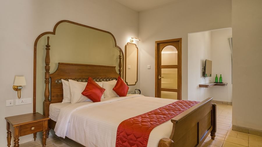 A double bed with side tables next to it inside the studio | Mango Hill Shola Ooty