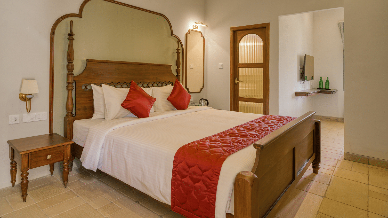A double bed with side tables next to it inside the studio | Mango Hill Shola Ooty