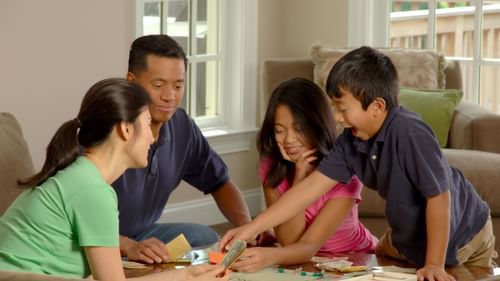 A family of four playing an indoor game together