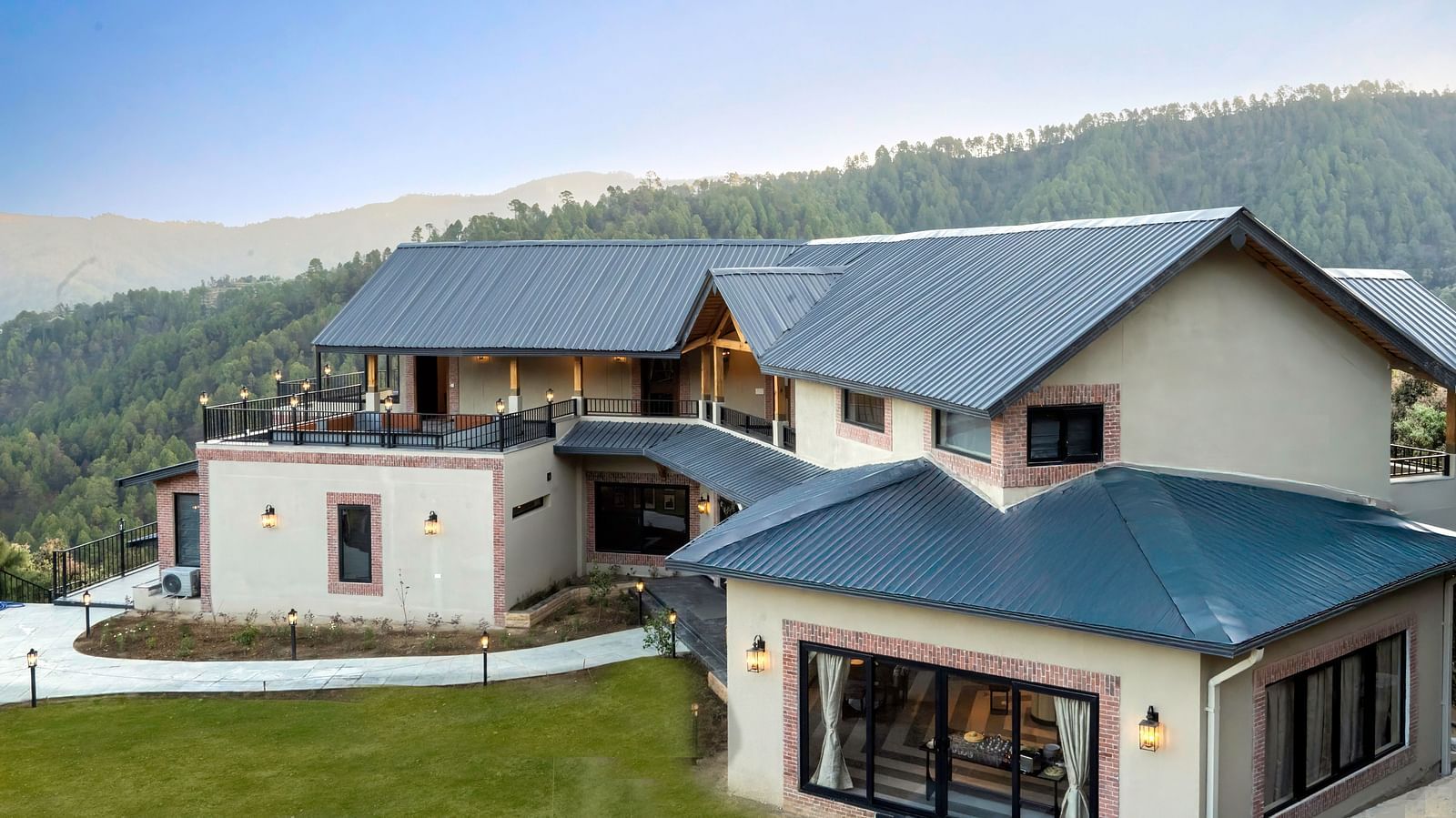 The Chamomile Estate's facade framed by the mountain and sky background.
