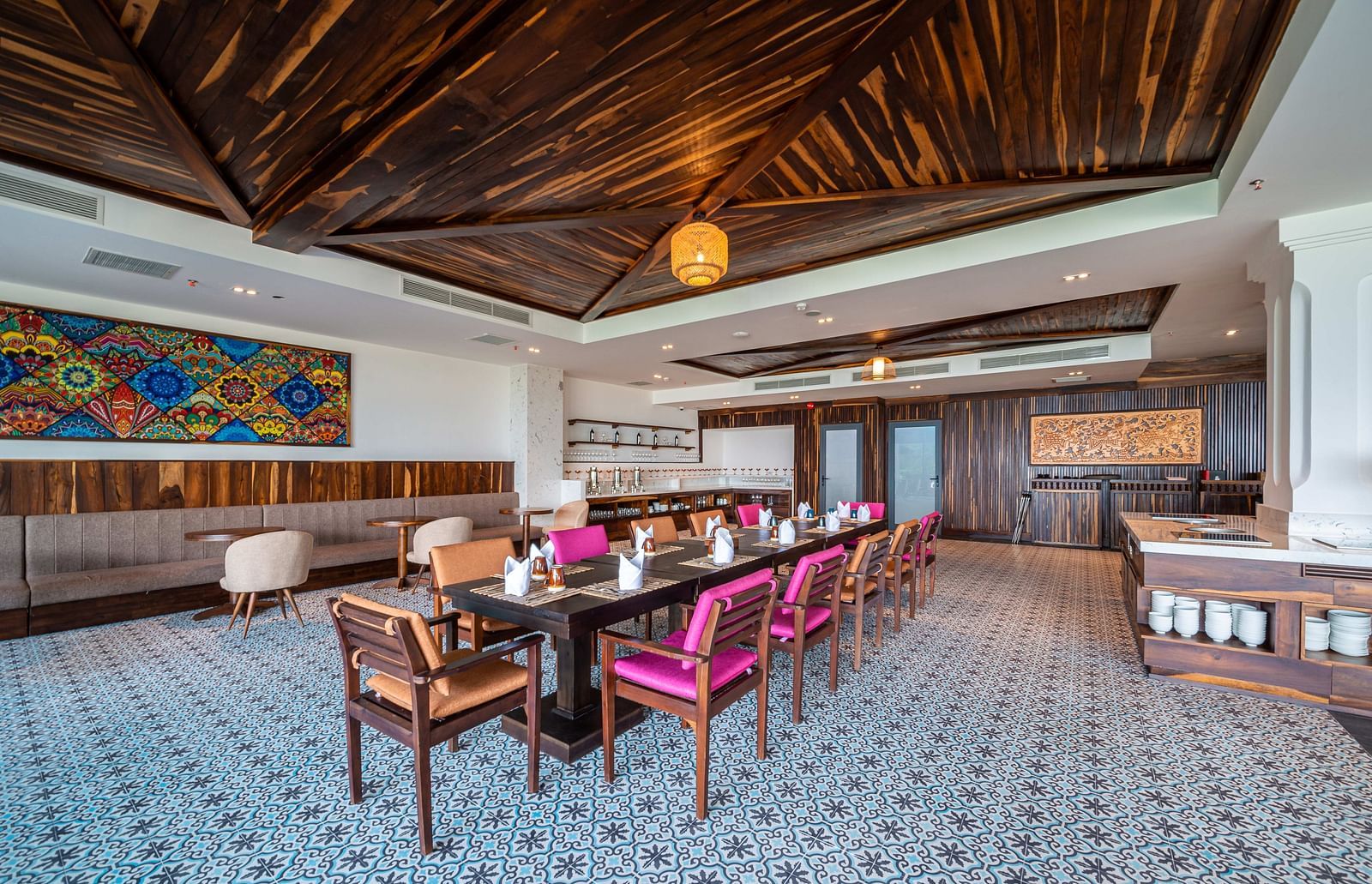 A long table seating arrangement in a restaurant with ambient lighting - Alibu Resort Nha Trang