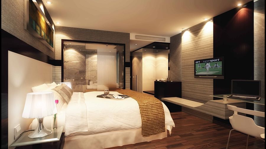 The bed offered by the Deluxe Room at  The Empressa Hotel