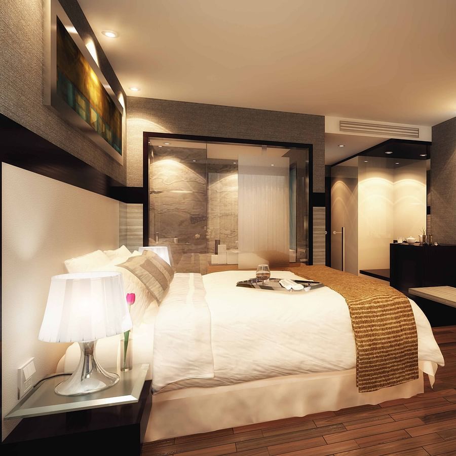 The Empresa Boutique Hotel - The view of the plush bed facing the TV of the deluxe room in Andheri