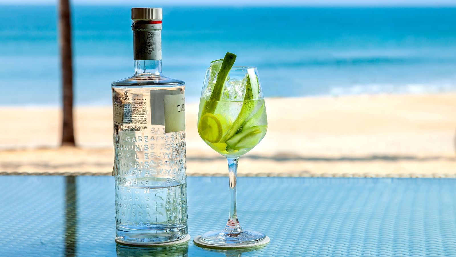 a bottle of a drink kept next to a champagne glass - Caravela Beach Resort Goa