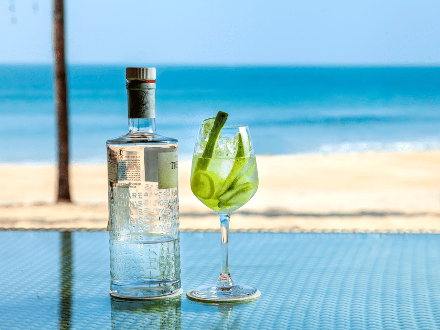 a bottle of a drink kept next to a champagne glass - Caravela Beach Resort Goa