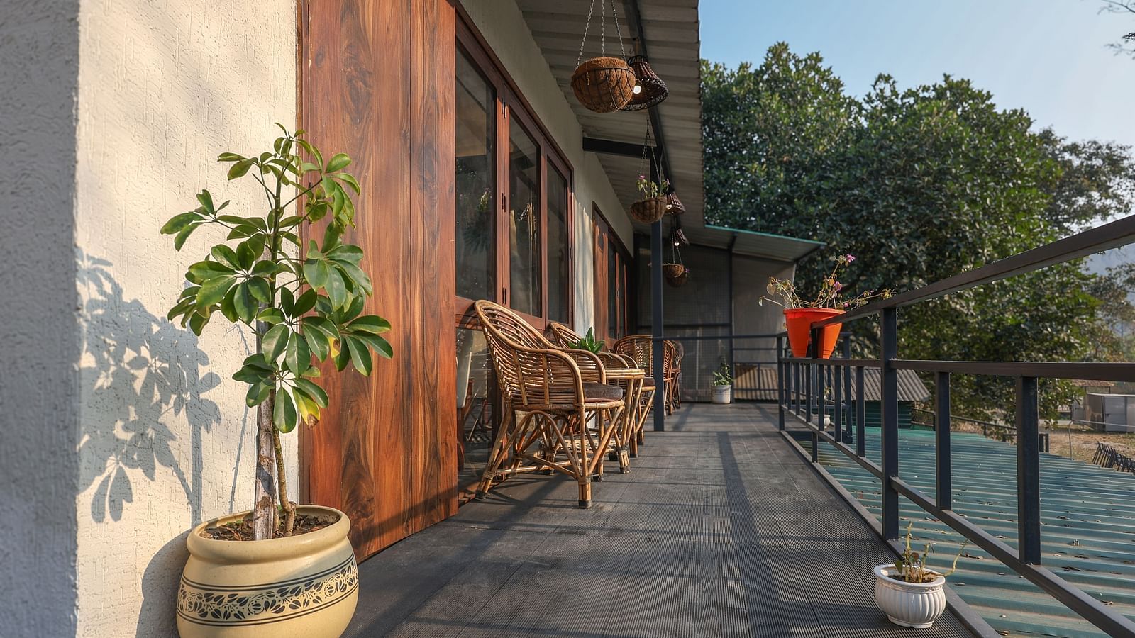 The balcony with chairs facing the view of River View Room at the Sylvan Retreat, Dehradun.