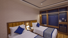 A comfortable hotel room in Brookefield with bedside lighting and modern decor - Grand Continent, Brookefield