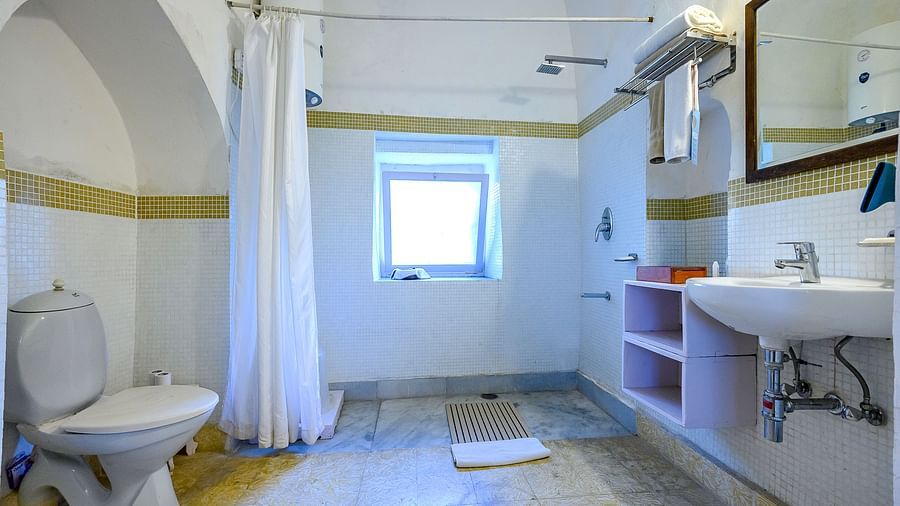 Hill Fort Kesroli 14th Century Alwar - interior view of Teetar Mahal - Pool View washroom featuring commode, wash basin, mirror and shower area