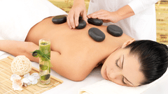 A woman getting a hot stone treatment done 3