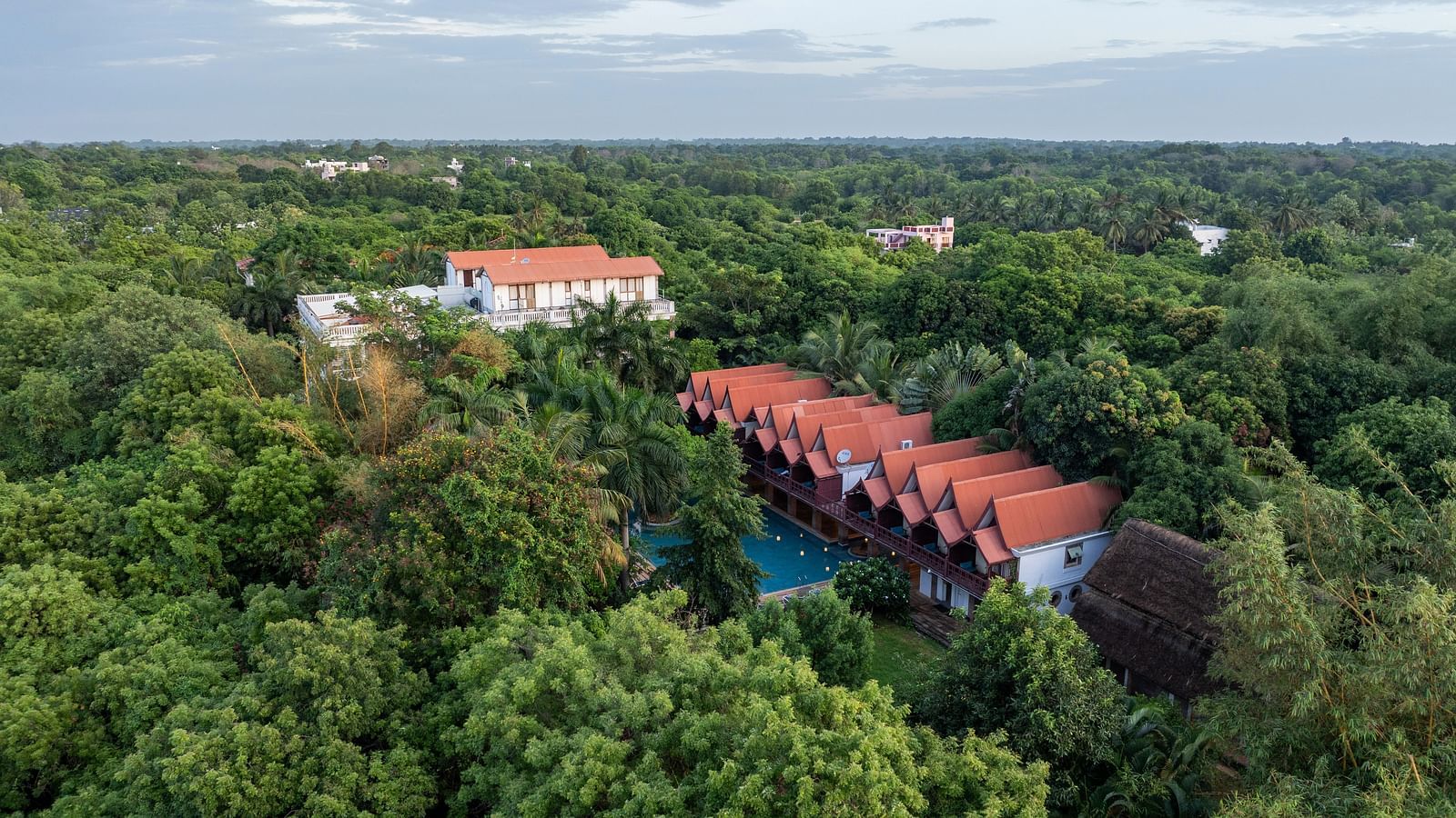 Top view of  the resort surrounded by trees.