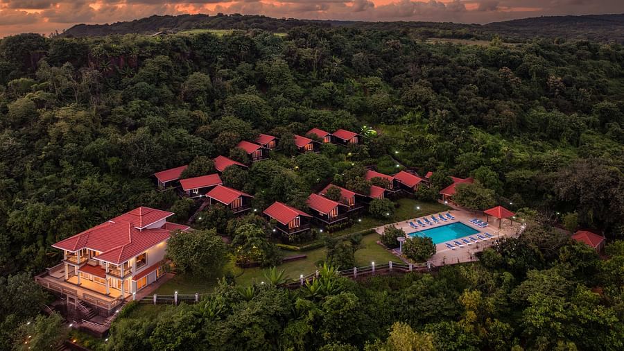 An image of a sunset-hued resort surrounded by nature - Highland Sarovar Portico, Sindhudurg
