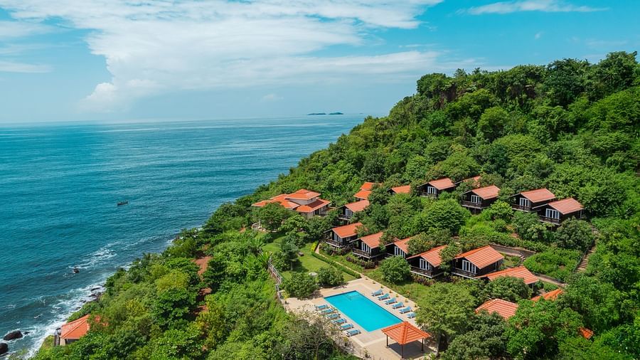 An aerial image of our resort in Sindhudurg covered with lush green trees by the side of the Arabian Sea - Highland Sarovar Portico, Sindhudurg