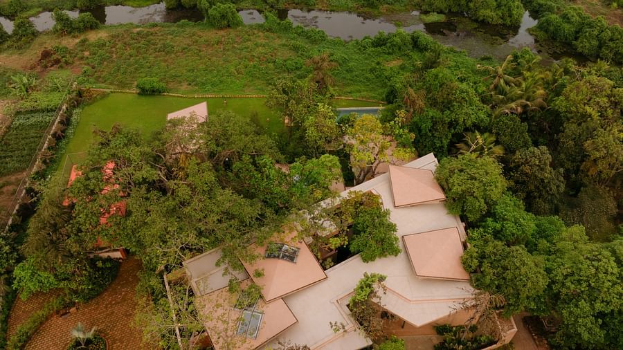 An aerial view of Villa Moira by V Escapes, showing the property nestled amongst lush greenery and trees.